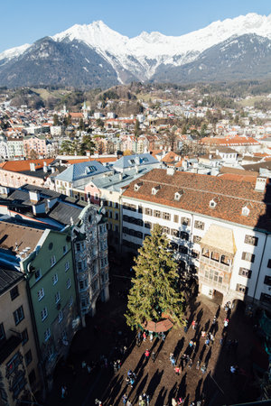 INNSBRUCK, AUSTRIA - DECEMBER 2018: view from Stadtturm tower over the town old center and Christmas tree on the market square.のeditorial素材
