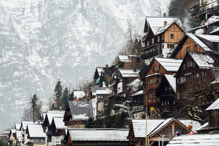 HALLSTATT, AUSTRIA - JANUARY 2019: view over wooden houses of old town and Alps mountains after snow storm.のeditorial素材