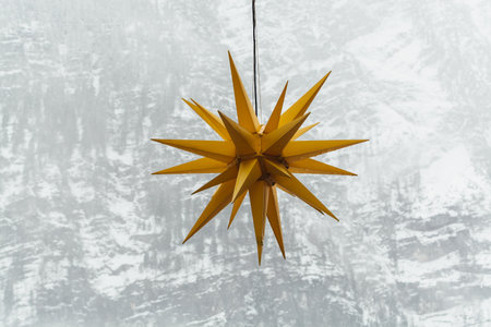 Yellow Christmas star with winter Alps mountains on the background in Hallstatt, Austria.の写真素材