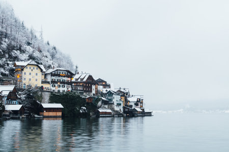 HALLSTATT, AUSTRIA - DECEMBER 2018: view over wooden houses of old town during winter snow stormのeditorial素材