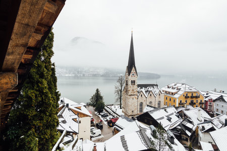 HALLSTATT, AUSTRIA - JANUARY 2019: view over Evangelische Pfarrkirche and old town at the lake front in winter.のeditorial素材