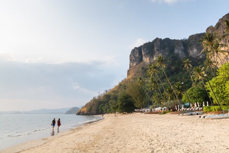 Young couple walking on Pai Plong beach at sunset in Krabi province, Thailand.のeditorial素材