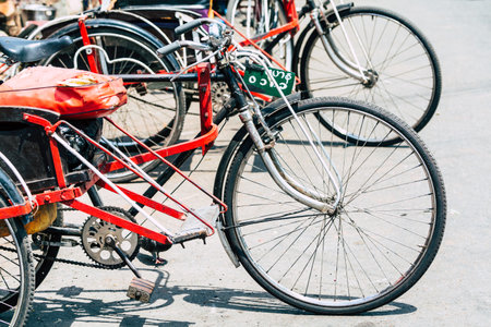 Yangon, Myanmar - March 2019: old empty rickshaw bicycles standing on the street.