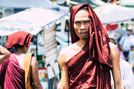 Yangon, Myanmar - March 2019: portrait of young Buddhist male novice monk at the full moon ceremony in Shwedagon pagoda temple complex.のeditorial素材