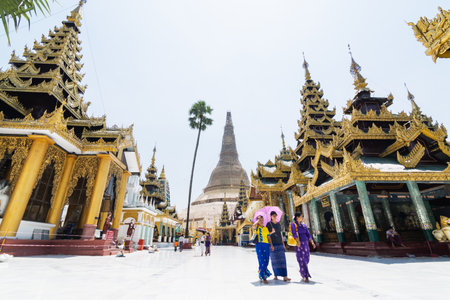 Yangon, Myanmar - March 2019: tourists walk in Shwedagon pagoda temple complex.のeditorial素材