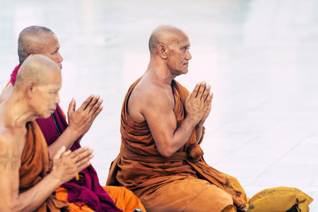 Yangon, Myanmar - March 2019: Buddhist monks pray in Shwedagon pagoda temple complex.のeditorial素材