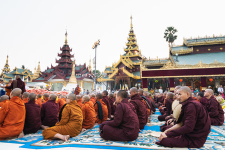 Yangon, Myanmar - March 2019: Buddhist monks during the official alms giving ceremony at Shwedagon pagoda.のeditorial素材