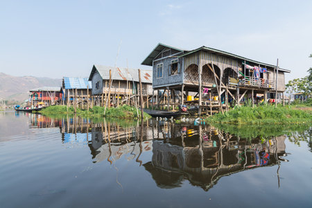 Maing Thauk, Myanmar - April 2019: traditional Burmese floating house reflecting in water of Inle lake.のeditorial素材