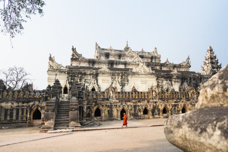 Inwa, Myanmar - April 2019: Buddhist monk walking next to Me Nu Brick Monastery in Mandalay region.のeditorial素材