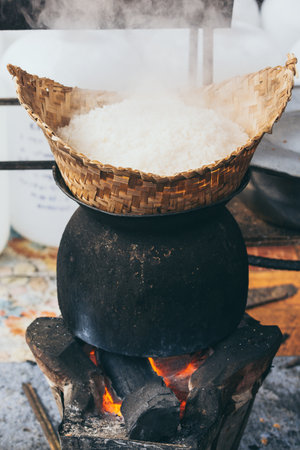 White laotian steam rice cooking on wood burning stove in Luang Prabang, Laos. Vertical orientationの写真素材