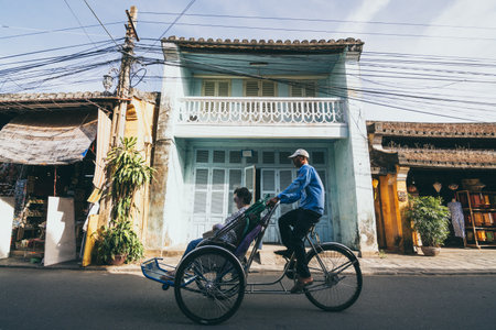 Hoi An, Vietnam - June 2019: bicycle rickshaws transporting tourists in the historic town centerのeditorial素材