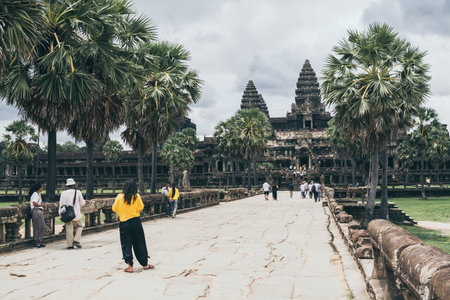 Siem Reap, Cambodia - June 2019: tourists walking towards main temple of Angkor Wat along Terrace of Honorのeditorial素材