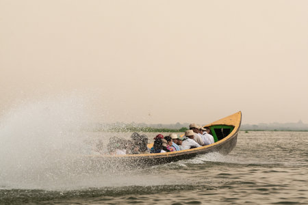 Inle, Myanmar - April 2019: Burmese people having boat ride on Inle lake in traditional long boatsのeditorial素材