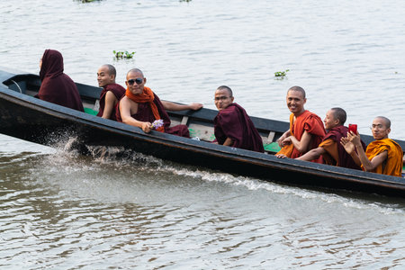Inle, Myanmar - April 2019: Burmese monks having boat ride on Inle lake in traditional long boatのeditorial素材