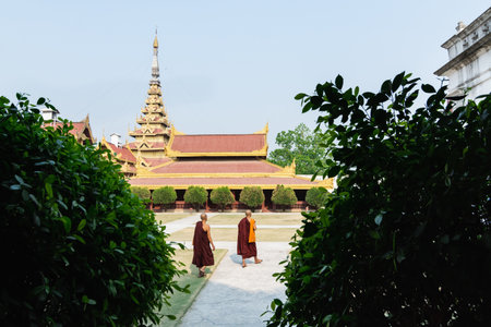 Mandalay, Myanmar - April 2019: two Buddhist monks walking in the backyard of Royal Palaceのeditorial素材