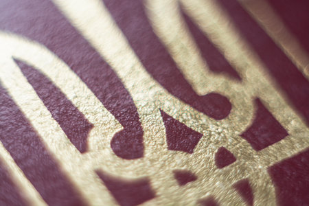 Kyiv, Ukraine - November 2019: close up of national Coat of Arms, emblem of Trident on passport coverのeditorial素材