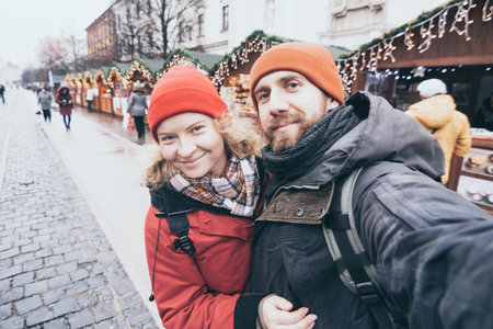 Young Caucasian couple making selfie at the Christmas market in Kosice, Slovakiaの写真素材