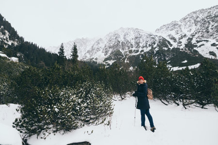 Woman trekking in snowy High Tatra mountains in winter close to Popradske Pleso, Slovakiaの写真素材