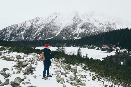 Woman trekking in snowy High Tatra mountains in winter close to Popradske Pleso, Slovakia