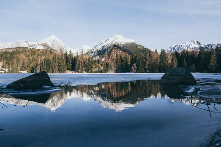 Strbske Pleso, Slovakia - December 2019: view over Patria hotel and High Tatra mountains reflecting in lake water.のeditorial素材