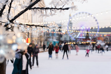 Kyiv, Ukraine - January 2020: people on a skating rink at the Christmas market on Kontraktova...
