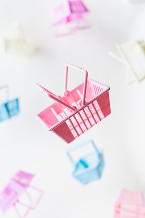 Levitating retail shopping baskets on white background. Vertical orientation