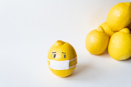 Lemon wearing medical mask isolated from the crowd. Conceptual image of social distancing.の写真素材