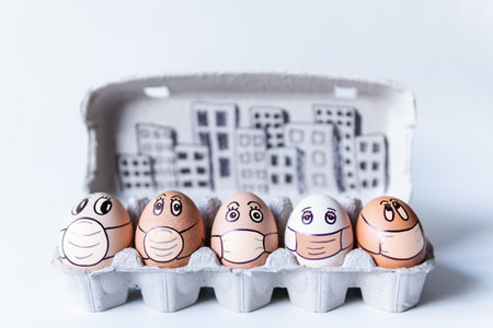 Diverse chicken eggs with doodle faces wearing medical masks with a city skyline on the background. Conceptual image of pollution and epidemyの写真素材