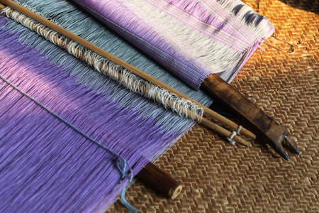 Vintage wooden parts of the loom with woven cloth on background. Handicrafts of Inle lake, Myanmarの写真素材
