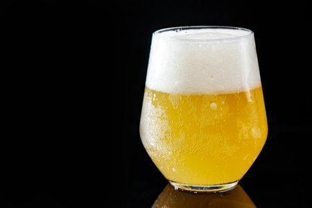 close-up of a beautiful glass with beer on a black backgroundの写真素材