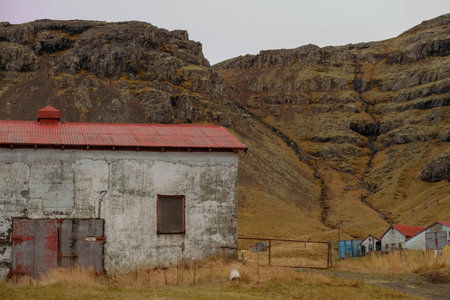 Old warehouse in small village with mountain backgoundの写真素材