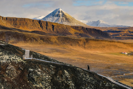 traveller walk on the wood path to claim the mountain with beautiful landscape baclground in morning time cloudy dayの写真素材