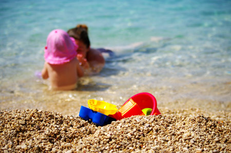 Mother and baby playing on the beachの写真素材
