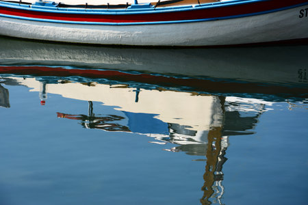 reflection of the old wooden fishing boatの写真素材