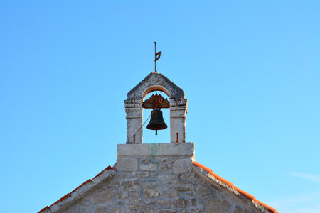 Small old church tower with bell in Split, Croatiaの写真素材
