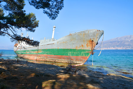 old cargo boat stranded on the rocks in croatiaの写真素材
