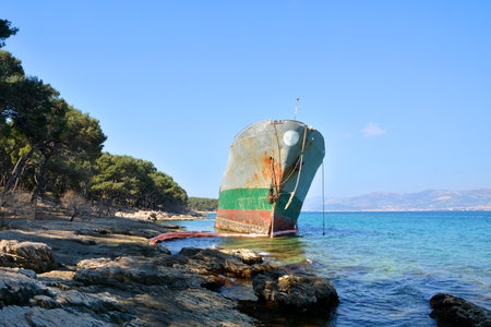 old cargo boat stranded on the rocks in croatiaの写真素材