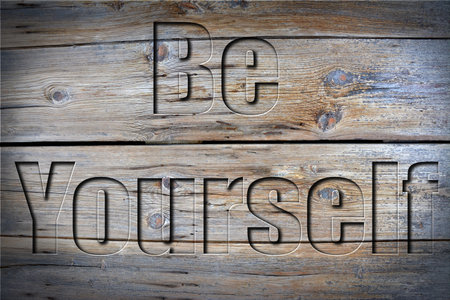 Be yourself engraved on old grunge woodの写真素材
