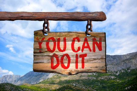 You can do it motivational phrase sign on old wood with blurred backgroundの写真素材