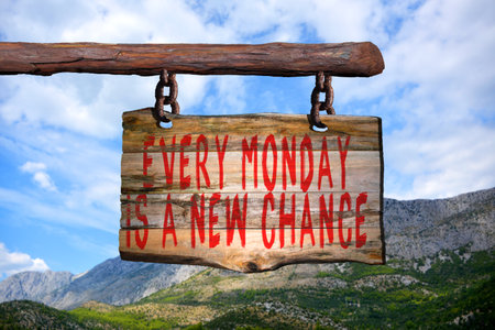 Every monday is a new chance motivational phrase sign on old wood with blurred backgroundの写真素材