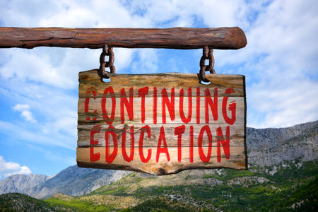 Continuing education motivational phrase sign on old wood with blurred backgroundの写真素材