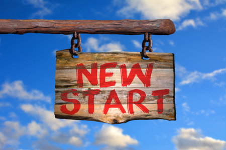 New start motivational phrase sign on old wood with blurred backgroundの写真素材