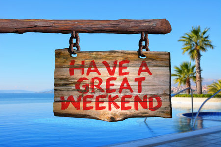 Have a great weekend motivational phrase sign on old wood with blurred backgroundの写真素材