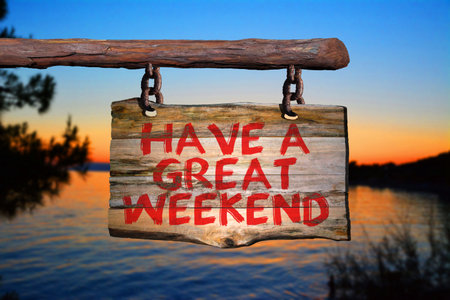 Have a great weekend motivational phrase sign on old wood with blurred backgroundの写真素材