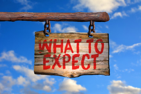 What to expect motivational phrase sign on old wood with blurred backgroundの写真素材
