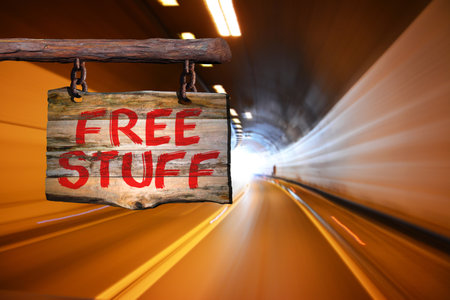 Free stuff motivational phrase sign on old wood with blurred backgroundの写真素材
