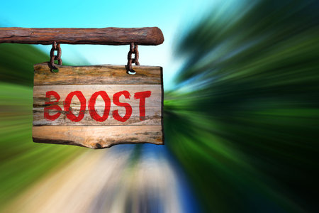 Boost motivational phrase sign on old wood with blurred backgroundの写真素材