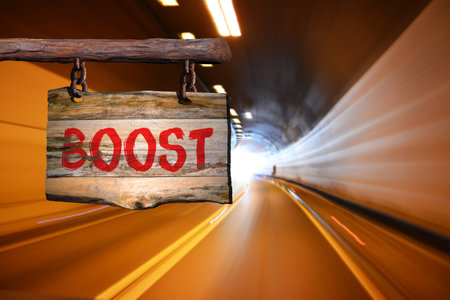Boost motivational phrase sign on old wood with blurred backgroundの写真素材