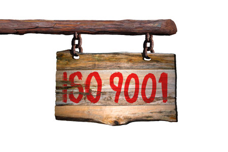 iso 9001 motivational phrase sign on old wood with blurred backgroundの写真素材