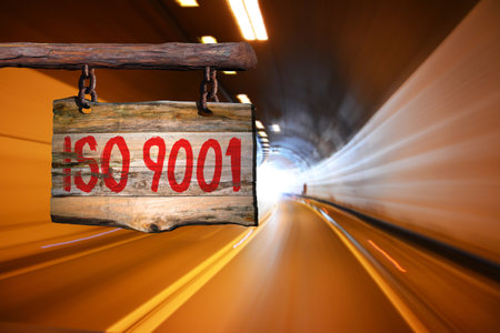iso 9001 motivational phrase sign on old wood with blurred backgroundの写真素材